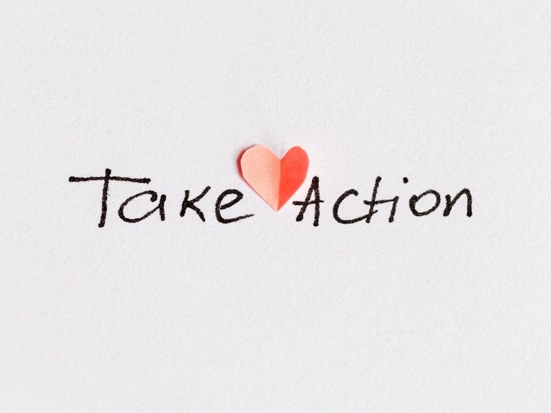 Take Action written in handwriting with heart symbol representing aligned action in manifestation process